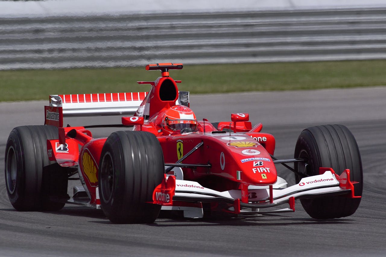 Ferrari Formula One car speeding on track at Indianapolis, showcasing performance and speed.