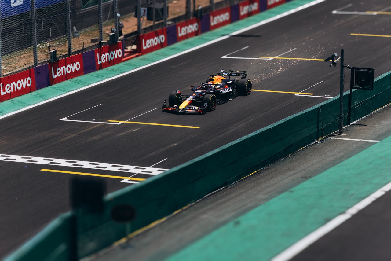 A Formula 1 car speeds down the track during a race, showcasing high performance.
