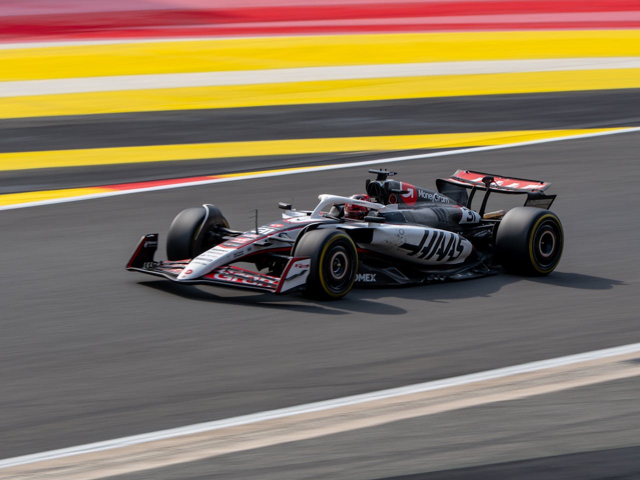 Rapid Formula 1 car speeding on a colorful track in Belgium.