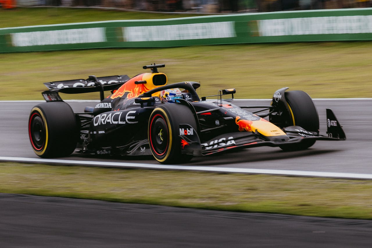 Dynamic shot of a Formula 1 race car speeding at the Interlagos track in São Paulo, Brazil.